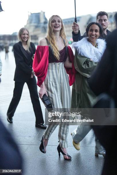 Sophie Turner wears a low-neck top, striped high waist pants, outside Louis Vuitton, during the Womenswear Fall/Winter 2024/2025 as part of Paris...