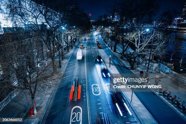 traffic travelling on multiple lane thoroughfare at night, london - vehicle light stock pictures, royalty-free photos & images