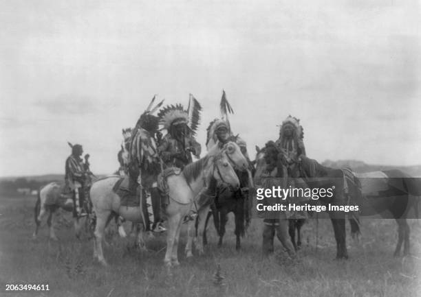 The Parley, circa 1908. Dakota men on horseback, one dismounted. Creator: Edward Sheriff Curtis.