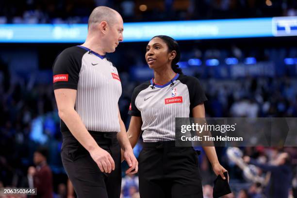 Referee Marat Kogut and referee Danielle Scott talk during a timeout in the game between the Indiana Pacers and the Dallas Mavericks at American...