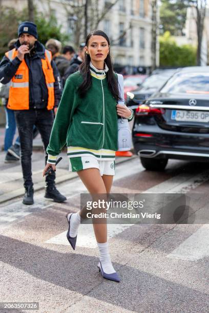 Barbara Ines wears green zipper jacket shorts, blue bag outside Lacoste during the Womenswear Fall/Winter 2024/2025 as part of Paris Fashion Week on...