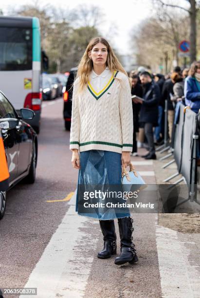 Veronika Heilbrunner wears beige v neck pullunder knit, denim skirt, Louis Vuitton bag in blue, white button shirt outside Lacoste during the...