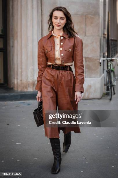 Mary Leest wears brown crop leather jacket with matching crop pants, beige shirt, black boots, black bag, outside Zimmermann, during the Womenswear...