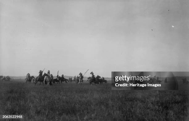 Morning attack, circa 1907. Dakota Indians on horseback on plains. Creator: Edward Sheriff Curtis.