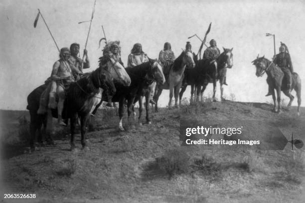 Watching for the signal, circa 1908. Apsaroke Indians on horseback: Wolf, Which Way, Fish Shows, Lone Tree, Child in the Mouth, Medicine Crow,...