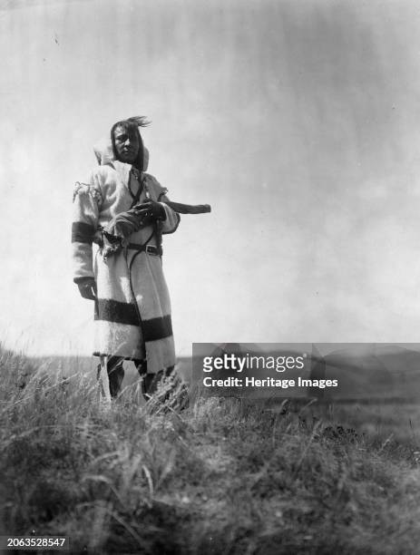 Piegan scout, circa 1910. Piegan man stands with open prairie behind him. Creator: Edward Sheriff Curtis.