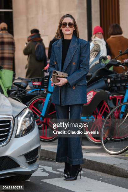 Olivia Palermo wears black top, blue denim blazer with matching flared jeans, taupe Hermes bag, black heels, outside Zimmermann, during the...