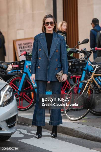 Olivia Palermo wears black top, blue denim blazer with matching flared jeans, taupe Hermes bag, black heels, outside Zimmermann, during the...