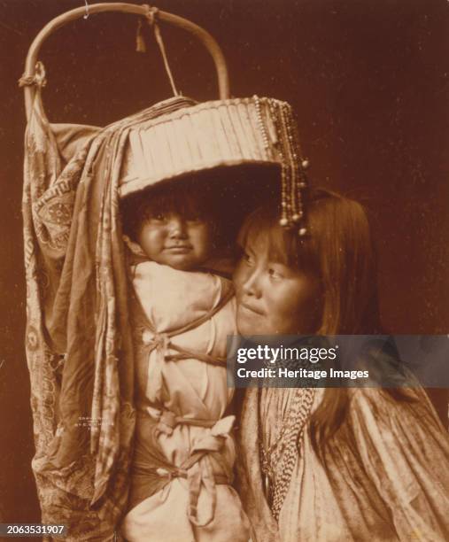 Apache girl and papoose, circa 1903. Creator: Edward Sheriff Curtis.