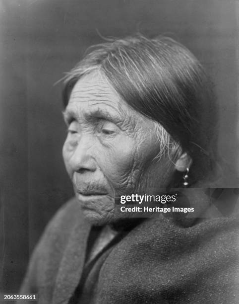 Chimakum woman, circa 1913. Chimakum woman, head-and-shoulders portrait, facing left. Creator: Edward Sheriff Curtis.