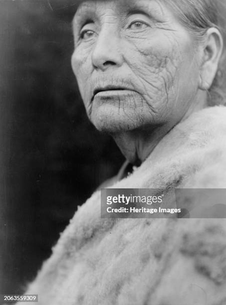 Hupa woman, circa 1923. Hupa woman, head-and-shoulders portrait, facing left. Creator: Edward Sheriff Curtis.