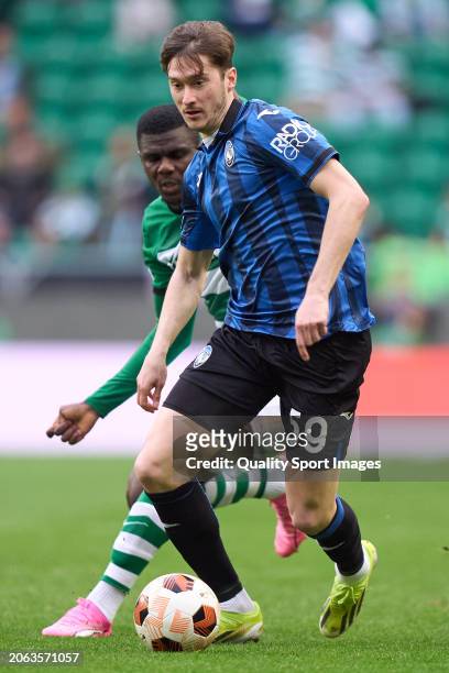 Ousmane Diomande of Sporting CP competes for the ball with Aleksey Miranchuk of Atalanta during the UEFA Europa League 2023/24 round of 16 first leg...