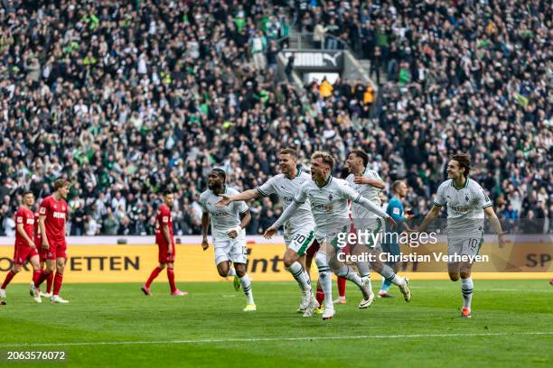 Robin Hack of Borussia Moenchengladbach and his teammates celebrate their third goal during the Bundesliga match between Borussia Moenchengladbach...