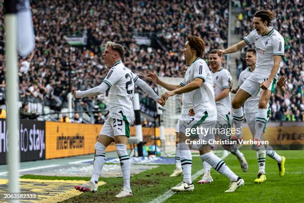 Robin Hack of Borussia Moenchengladbach and his teammates celebrate their third goal during the Bundesliga match between Borussia Moenchengladbach...