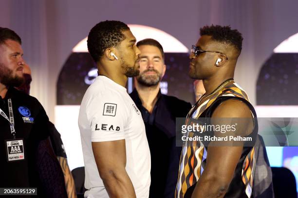 Anthony Joshua and Francis Ngannou face-off at the press conference ahead of their 'Knockout Chaos' heavyweight fight at Boulevard World on March 06,...