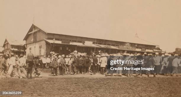 Crowds of people in front of buildings at the marketplace in the center of town, Vladivostok, Russia, . In album: Photographs of Pray Family...