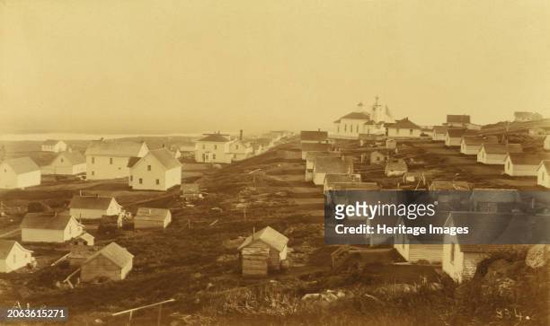 Unidentified village, possibly on Unalaska Island; Russian church with clock in the bell tower in the background,1894 or 1895. In album: Documentary...