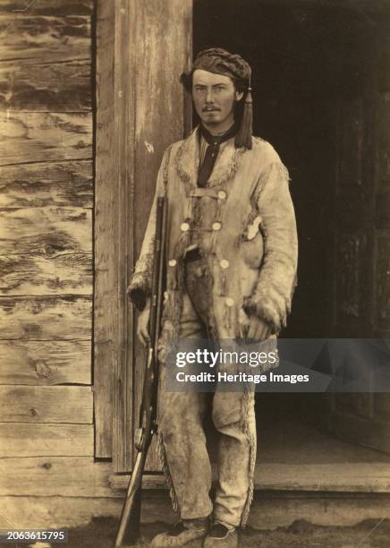 Charles W Wilson, full-length portrait, standing, facing front, wearing buckskins, with rifle, between 1858 and 1861. In: Photographs of British...