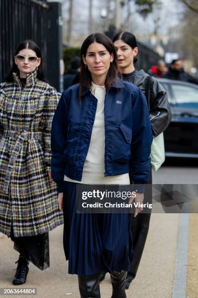 Deborah Reyner Sebag wears blue bomber jacket, pleated skirt outside Lacoste during the Womenswear Fall/Winter 2024/2025 as part of Paris Fashion...