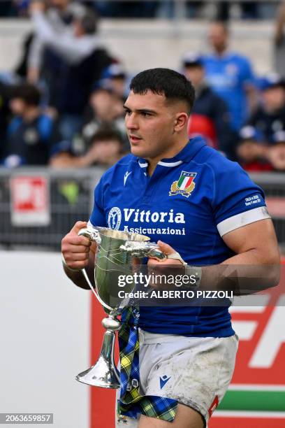 Italy's prop Danilo Fischetti holds the trophy for the best player of the match after winning the Six Nations rugby union international match between...