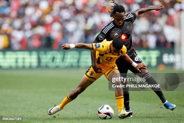Chiefs' South African defender Dillan Solomons fights for the ball with Pirate's Nigerian defender Olisa Ndah during the Premier Soccer League South...