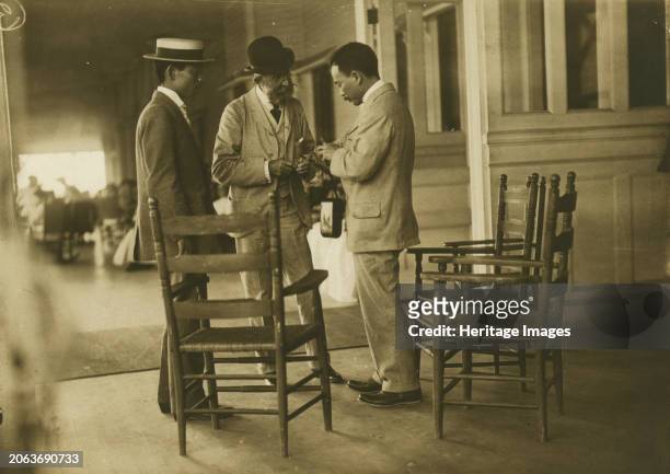 Two Japanese men and one American man, probably journalists, conversing on the veranda of the Wentworth Hotel, Portsmouth, N.H., 1905. Creator:...