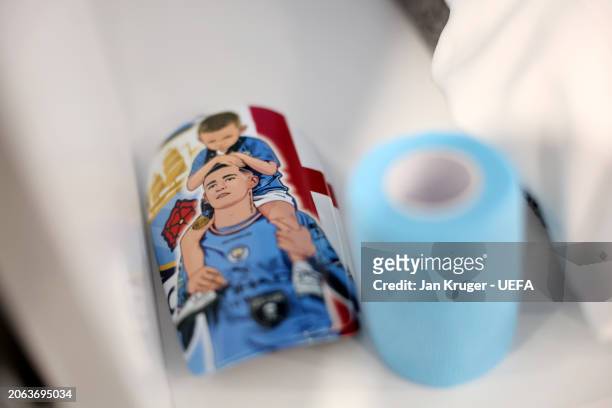 The shin guards of Phil Foden are displayed inside the Manchester City dressing room prior to the UEFA Champions League 2023/24 round of 16 second...