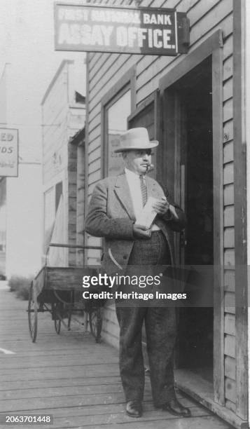 Delegate Wickersham, between circa 1900 and 1916. James Wickersham, full-length portrait, standing in front of a First National Bank Assay Office,...