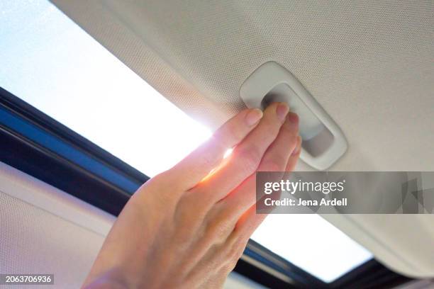 hand closing car sunroof, auto sunroof - draft period closes stock pictures, royalty-free photos & images