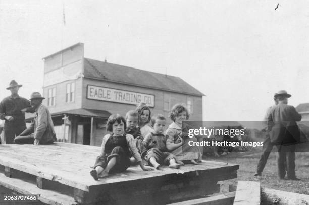Children outside Eagle Trading Company, between circa 1900 and 1916. Creator: Unknown.