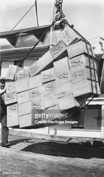 Loading boxes of salmon Petersburg, between circa 1900 and circa 1930. Creator: Unknown.