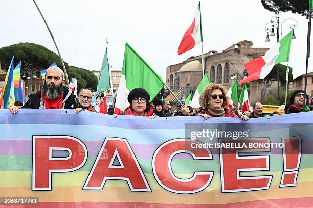 Demonstrators hold a banner which reads "Peace" during a national peace demonstration in Rome on March 9, 2024.