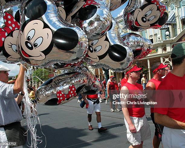 "Gays Days" visitors walk along Main Street at Disney World's Magic Kingdom during "Gay Days" weekend organized by Gay Days Inc. June 7, 2003 in...