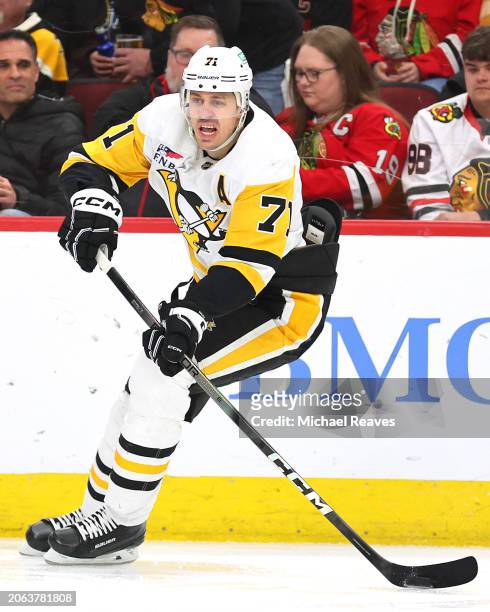 Evgeni Malkin of the Pittsburgh Penguins skates with the puck against the Chicago Blackhawks during the second period at the United Center on...
