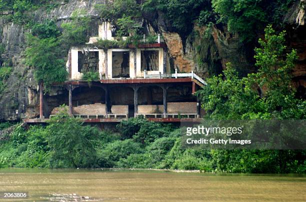 The waters of the Yangtze River rise toward an abandoned house in the Wu Gorge June 7, 2003 outside Wushan, China. The house will be submerged by the...