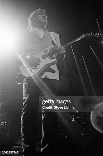Canadian Rock musician Alex Lifeson, of the group Rush, plays electric guitar as he performs onstage at Nassau Coliseum , Uniondale, New York, April...