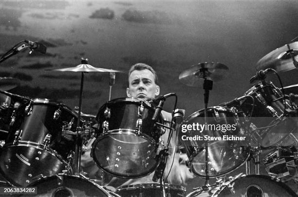 Canadian Rock musician Neil Peart , of the group Rush, plays drums as he performs onstage at Nassau Coliseum , Uniondale, New York, April 22, 1990.