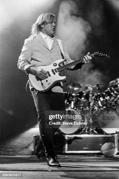 Canadian Rock musician Alex Lifeson, of the group Rush, plays electric guitar as he performs onstage at Nassau Coliseum , Uniondale, New York, April...