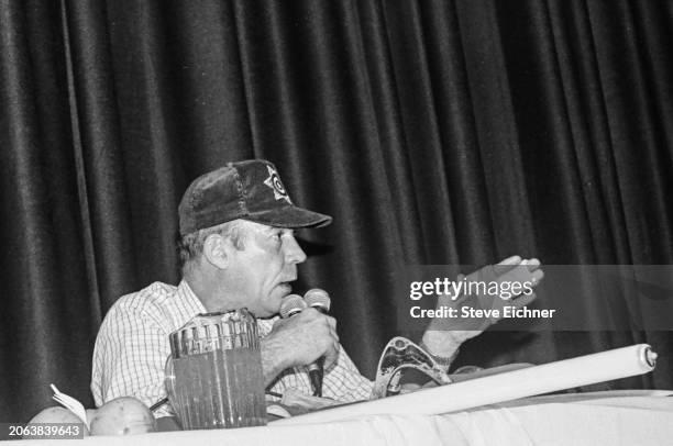 American journalist & author Hunter S Thompson holds two microphones as he speaks onstage at Columbia University , New York, New York, April 18, 1990.