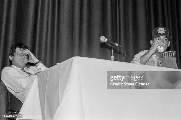 View of American magazine publisher & Rolling Stone co-founder Jann Wenner and journalist & author Hunter S Thompson onstage during an appearance at...