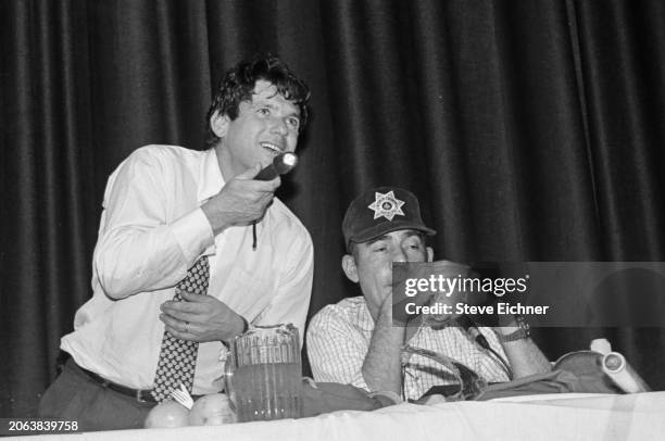 View of American magazine publisher & Rolling Stone co-founder Jann Wenner and journalist & author Hunter S Thompson onstage during an appearance at...