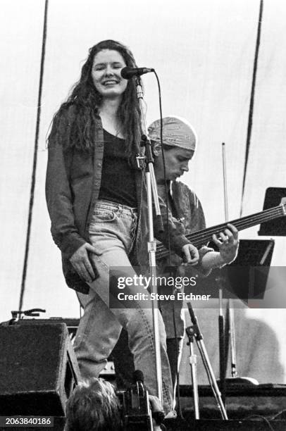 American Folk Rock musicians Edie Brickell & Brad Houser , on bass, both of the group Edie Brickell & New Bohemians, perform onstage during the Earth...
