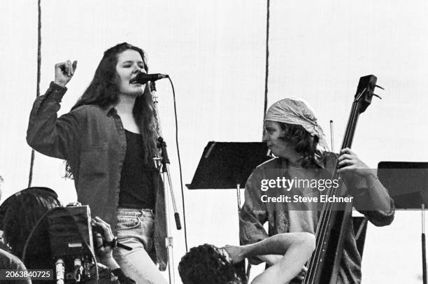 American Folk Rock musicians Edie Brickell & Brad Houser , on bass, both of the group Edie Brickell & New Bohemians, perform onstage during the Earth...