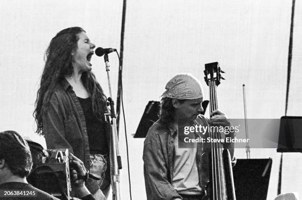 American Folk Rock musicians Edie Brickell & Brad Houser , on bass, both of the group Edie Brickell & New Bohemians, perform onstage during the Earth...