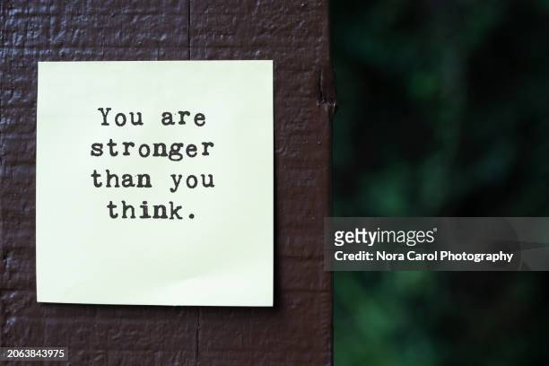 adhesive note with inspirational quotes you are stronger than you think - health motivational quotes stock pictures, royalty-free photos & images