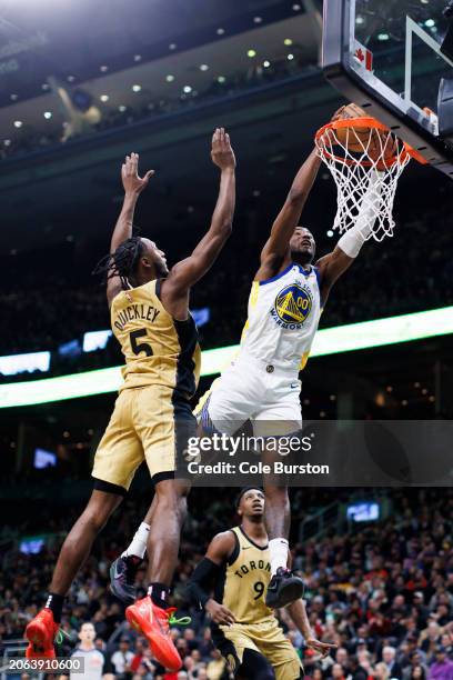 Jonathan Kuminga of the Golden State Warriors dunks against Immanuel Quickley of the Toronto Raptors during the second half of their NBA game at...