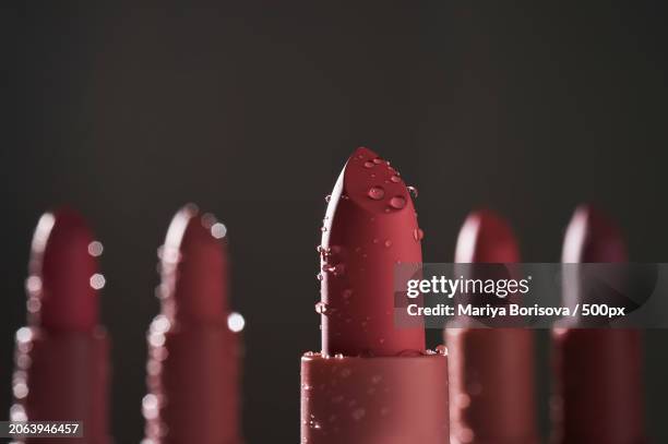 close-up of red candles against black background - red lipstick stick stock pictures, royalty-free photos & images