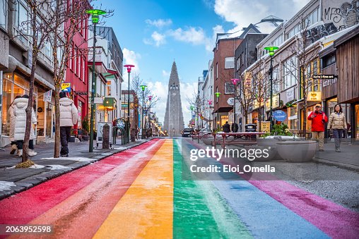 People walking on the rainbow painted Skolavordustigur street People walking on the rainbow painted Skolavordustigur street