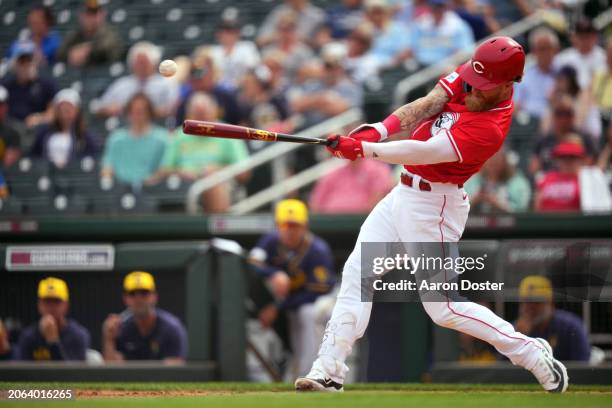 Jake Fraley of the Cincinnati Reds singles in the second inning during a spring training game against the Milwaukee Brewers at Goodyear Ballpark on...