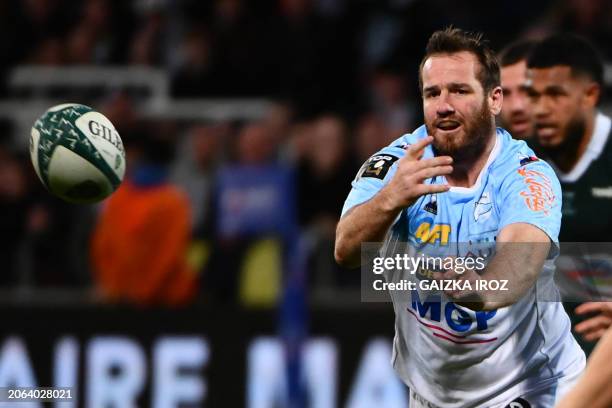 Bayonne's French fly-half Camille Lopez passes the ball during the French Top 14 rugby union match between Section Paloise and Aviron Bayonnais at...